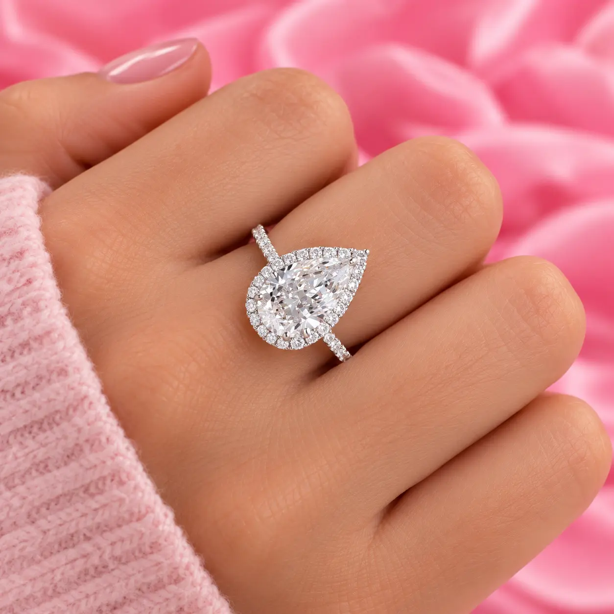 Pear-shaped diamond ring with a diamond halo